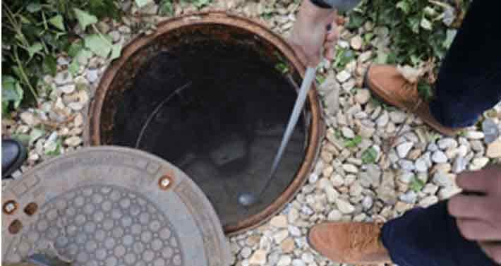 inspecting septic tank drain