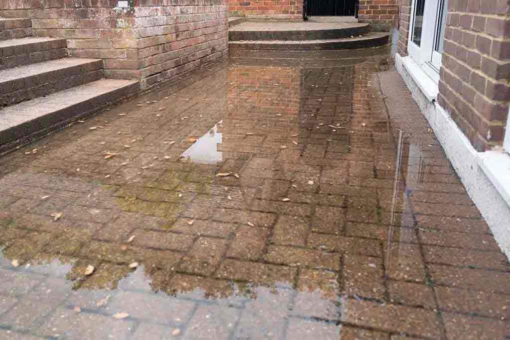 flooded patio caused by blocked septic tank and soakaway